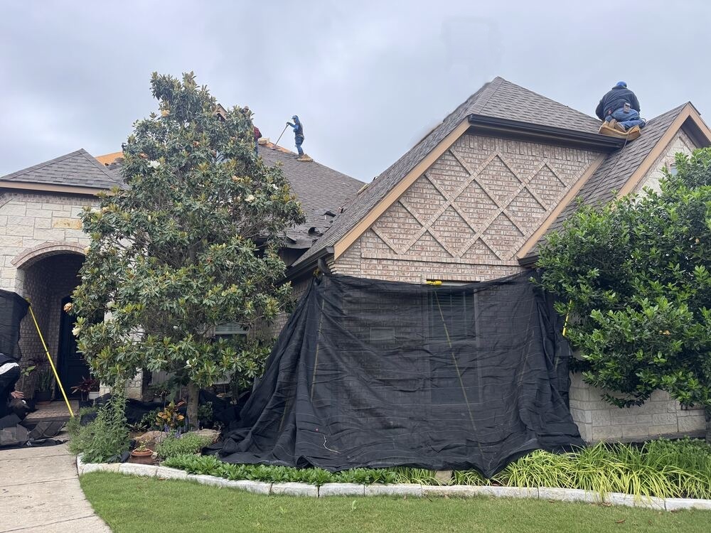 Job site prepped with protective tarps before roof tear-off